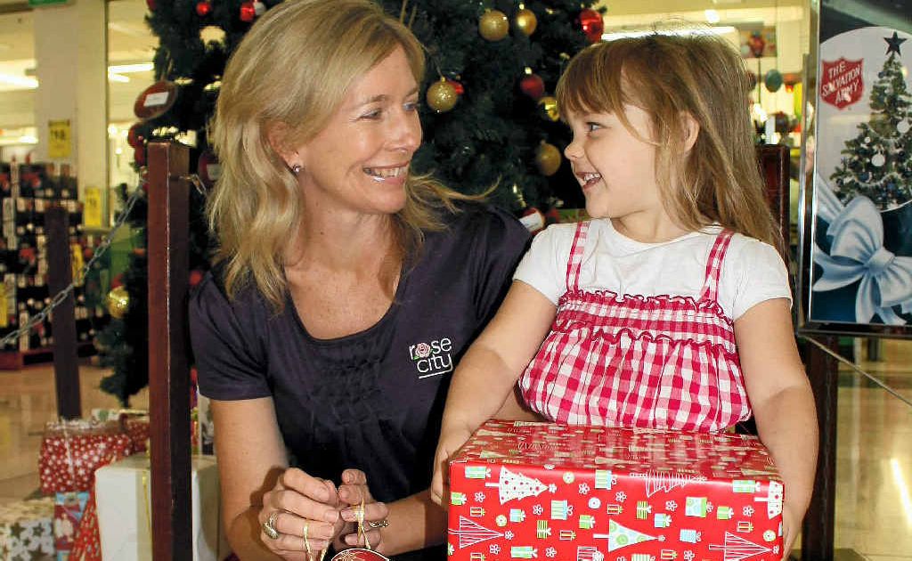 Rose City Shoppingworld marketing manager Louise de Lissa and Lucy Read, 3, place some gifts under the Wishing Tree. Rose City Shoppingworld marketing manager Louise de Lissa and Lucy Read, 3, place some gifts under the Wishing Tree.